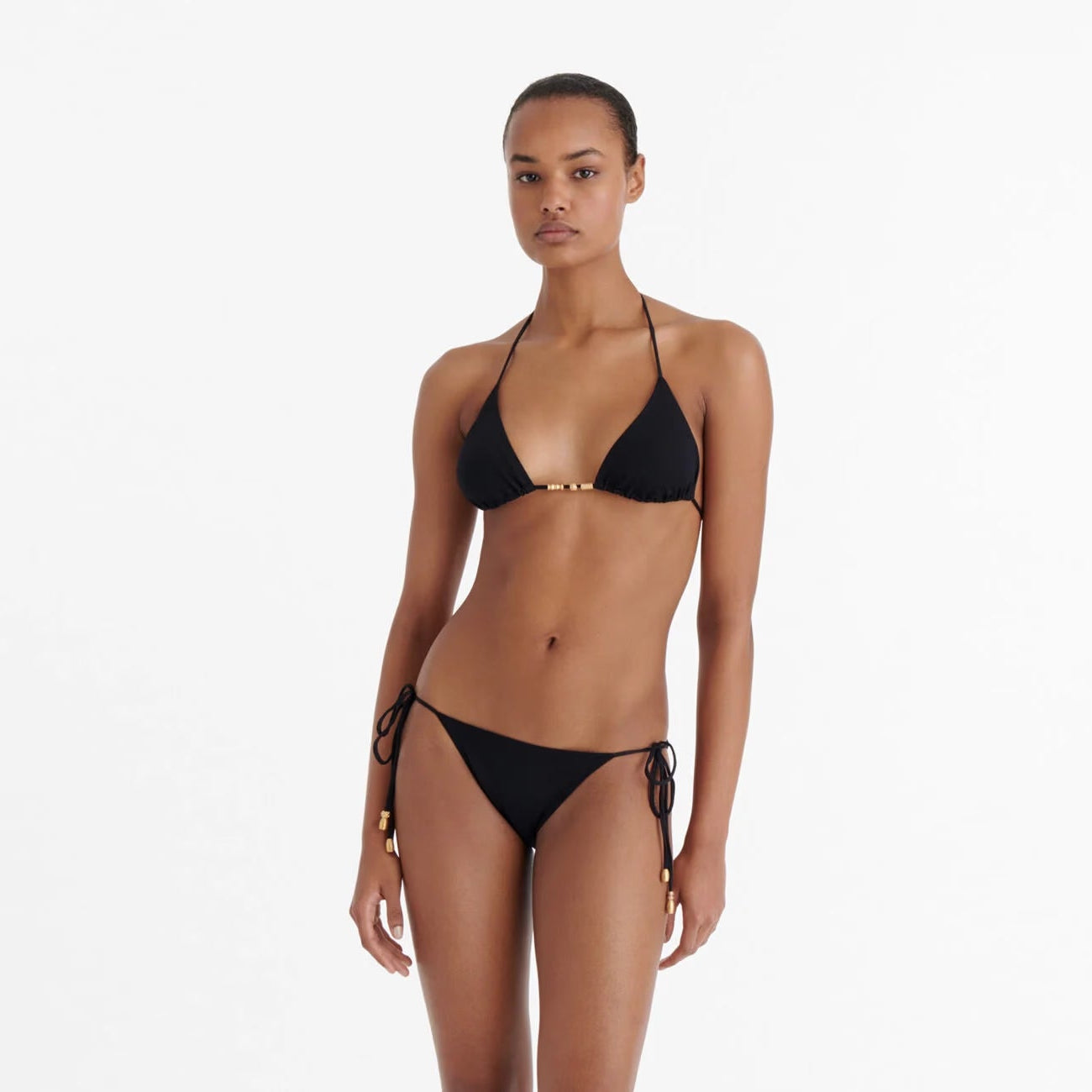 Woman wearing a black bikini available at LaSource in Darien, New Canaan and Westport