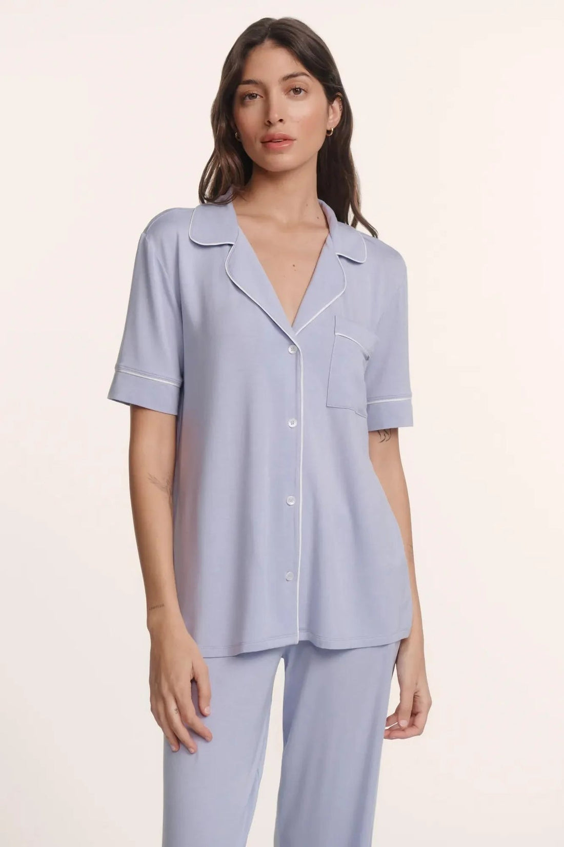 Woman relaxing in elegant, softly lit sleepwear