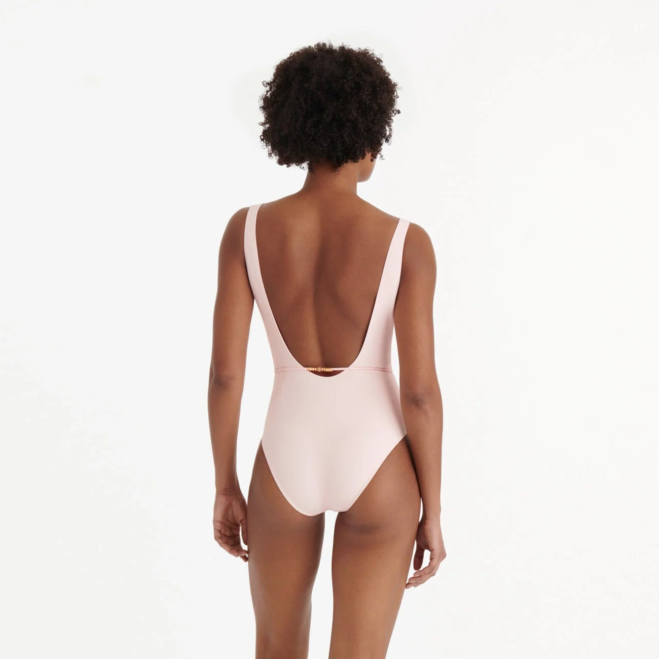 Person wearing a light pink swimsuit with a white background  available at LaSource in Darien, New Canaan and Westport