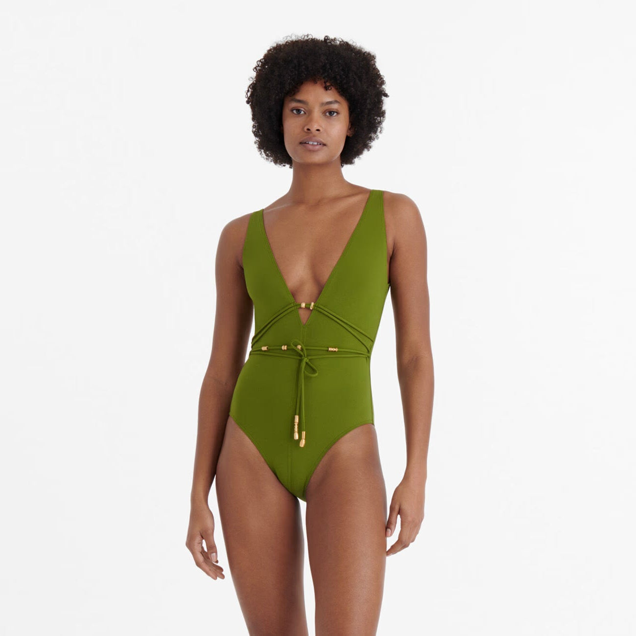 Woman wearing a green swimsuit on a white background available at LaSource in New Canaan, Darien and Westport