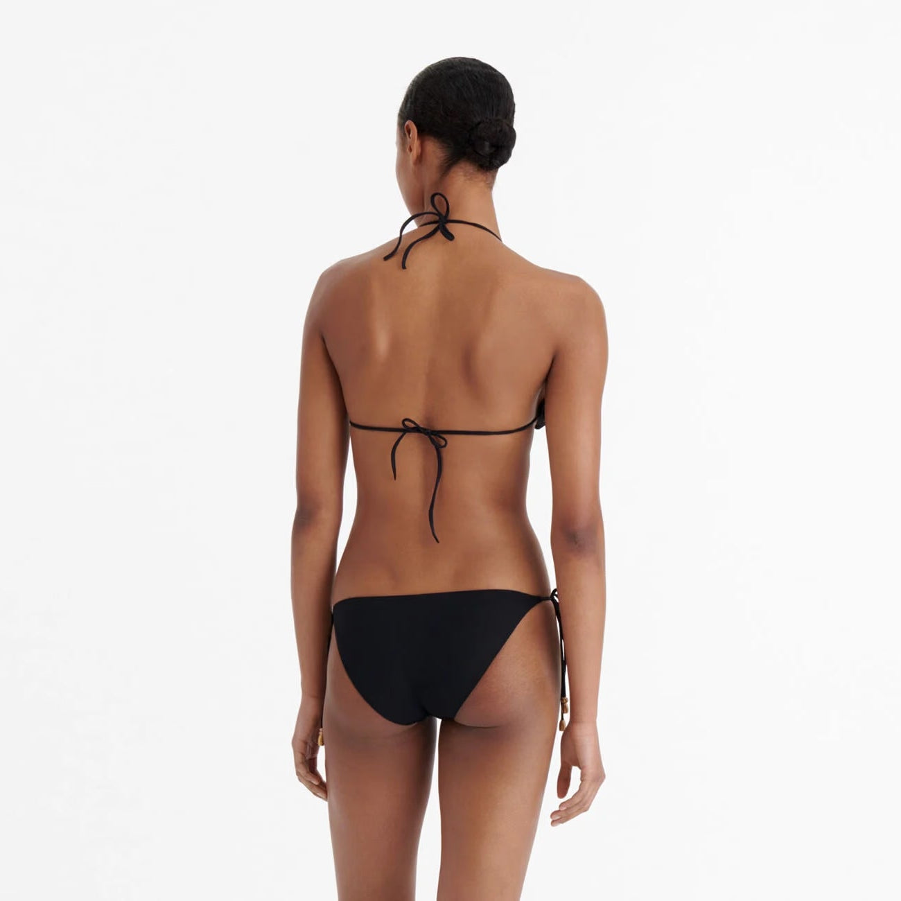 Woman wearing a black bikini on a white background available  at LaSource in Darien, New Canaan and Westport