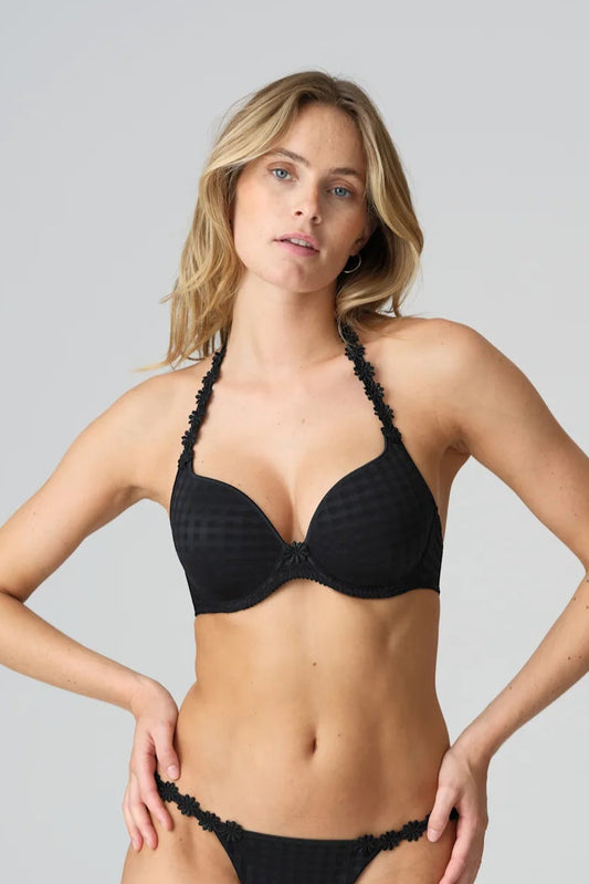 Woman wearing a black bikini against a gray background