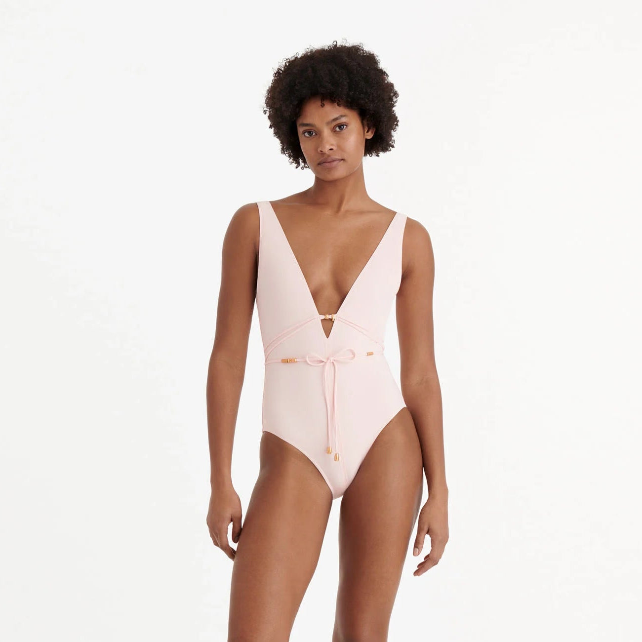 Woman wearing a pink swimsuit on a white background available at LaSource in Darien, New Canaan and Westport